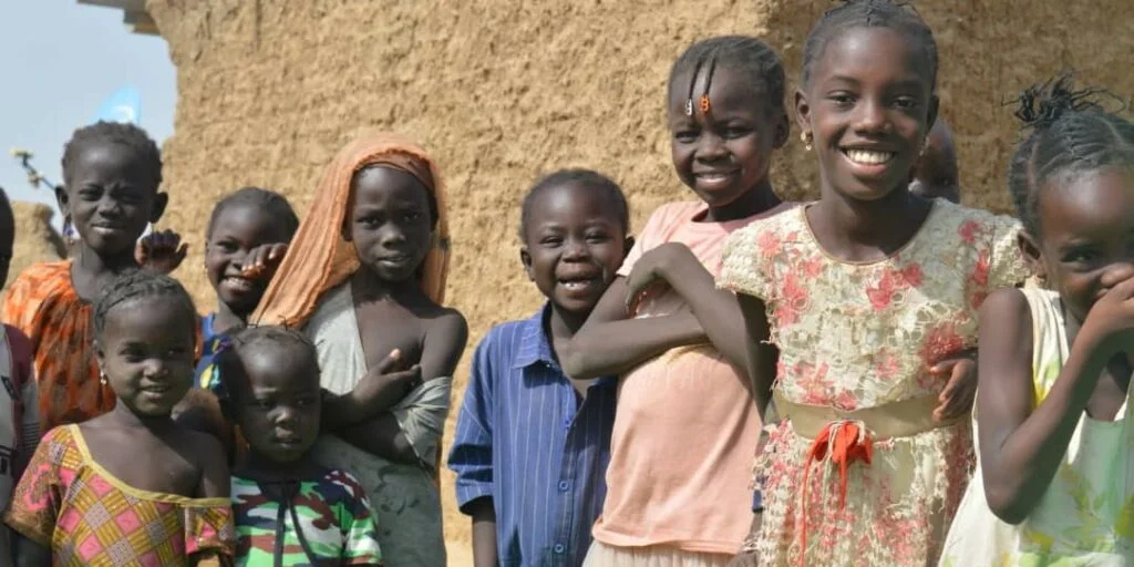Children smiling together in their community