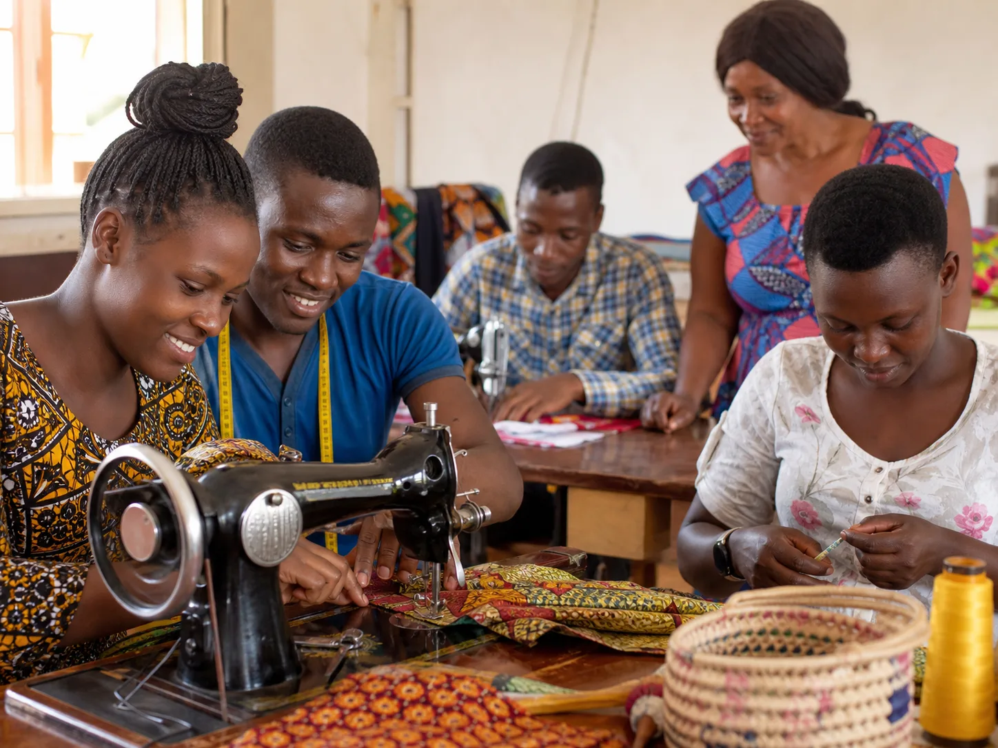 Young adults learning tailoring and crafts